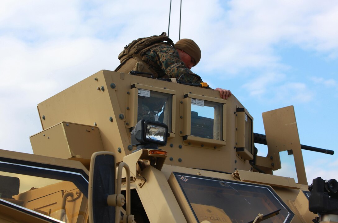 A Marine with Combat Logistics Battalion 6, 2nd Marine Logistics Group takes his spot behind a .50-caliber machine gun during a field exercise aboard Camp Lejeune, N.C., Feb. 28, 2013. The Marine used the weapon to provide security for a nine-vehicle convoy sent to assist in a helicopter support exercise. 