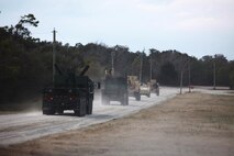 A convoy of vehicles departs a landing zone during a training exercise conducted by Combat Logistics Battalion 6, 2nd Marine Logistics Group aboard Camp Lejeune, N.C., Feb. 28, 2013. Thirty-one Marines with the battalion participated in the operation, which included route clearance and helicopter support exercises.