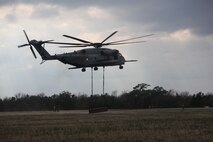 A CH-53E Super Stallion hauls away a railroad beam that used a training tool during a helicopter support mission during an exercise at landing zone Bluebird aboard Camp Lejeune, N.C., Feb. 28, 2013. A helicopter support team consists of eight Marines whose job it is to safely attach various pieces of gear and equipment to a helicopter. The CH-53E is the heaviest helicopter in the Marine Corps’ fleet and is capable of hauling 33,000 pounds. 