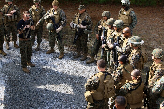 An instructor with Battle Skills Training School, 2nd Marine Logistics Group shows how to properly hold a rifle when clearing a room aboard Camp Lejeune, N.C., Feb. 27, 2013, during a week-long training period. Marines with Engineer Operation Company, Marine Wing Support Squadron 274, out of Marine Corps Air Station Cherry Point, N.C., learned combat skills, such as improvised explosive device detection, convoys and incident reporting procedures. 