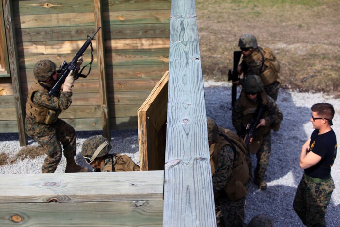 Marines with Engineer Operation Company, Marine Wing Support Squadron 274, out of Marine Corps Air Station Cherry Point, N.C., line up alongside a building aboard Camp Lejeune, N.C., Feb. 27, 2013, during a week-long course at Basic Skills Training School. Servicemembers learned how to clear rooms, detect improvised explosive devices and breach doors from BSTS instructors with 2nd Marines Logistics Group. 