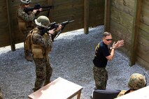 Sgt. Jacob W. Dofner, a McClelland, Iowa, native and an instructor with Battle Skills Training School, 2nd Marine Logistics Group, demonstrates how to properly clear a room aboard Camp Lejeune, N.C., Feb. 27, 2013, during a week-long training period. Marines with Engineer Operation Company, Marine Wing Support Squadron 274, out of Marine Corps Air Station Cherry Point, N.C., received classroom instructions on how to breach and clear rooms as they later that day performed practical applications. 