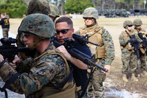 Sgt. Jacob W. Dofner, a McClelland, Iowa, native and an instructor with Battle Skills Training School, 2nd Marine Logistics Group, demonstrates how to properly enter a room as a group aboard Camp Lejeune, N.C., Feb. 27, 2013, during a week-long training period. Marines with Engineer Operation Company, Marine Wing Support Squadron 274, out of Marine Corps Air Station Cherry Point, N.C. learned and performed basic combat skills such as room clearing, improvised explosion device detection and assembling and disassembling machine guns.