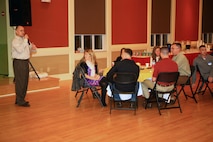 Jose L. Padilla, (left), a Guanica, Puerto Rico, native and the family readiness officer with Combat Logistics Regiment 27, 2nd Marine Logistics Group, speaks to servicemembers about future events during a meet and greet at Marston Pavilion aboard Camp Lejeune, N.C., Feb. 27, 2013. The volunteers and the family readiness officer set up before the night’s festivities which include Col. Gary F. Keim, the commanding officer of the regiment, meeting and socializing with families. 