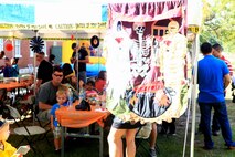 Marines and Sailors with Combat Logistics Regiment 27, 2nd Marine Logistics Group enjoy snacks at a haunted house aboard Camp Lejeune, N.C., Oct. 21, 2012. The volunteers with the regiment turned CLR-27’s headquarters building to a haunted structure for the unit’s families. 