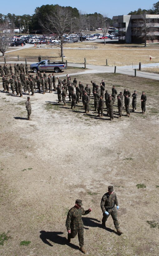 Marines wait during a health-and-comfort inspection, while others move to inspect a new area at the barracks of 8th Engineer Support Battalion aboard Marine Corps Base Camp Lejeune March 4. The health-and-comfort inspection was conducted by the commanding officer of 8th ESB with support from the Provost Marshall’s Office, 2nd Law Enforcement Battalion, Jacksonville Police Department and the base’s Special Response Team.