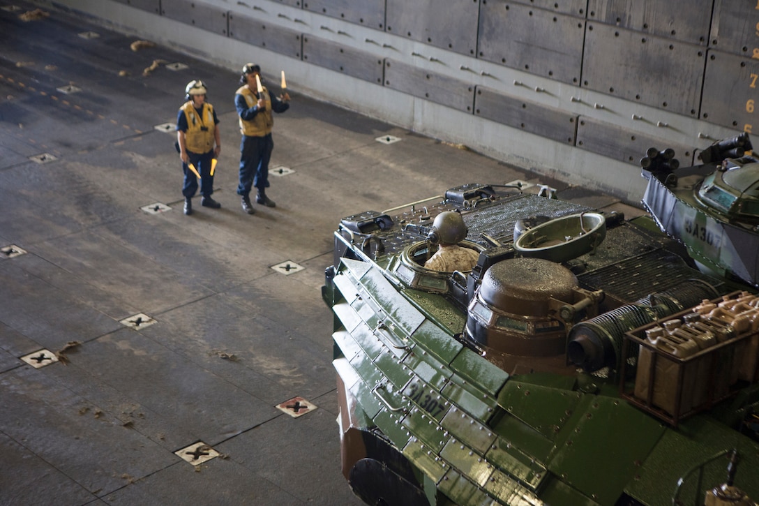 Sailors with Battalion Landing Team 3/5, 15th Marine Expeditionary Unit, direct an amphibious assault vehicle into the well deck of the USS Green Bay, March 9. The 15th MEU is deployed as part of the Peleliu Amphibious Ready Group as a U.S. Central Command theatre reserve force, providing support for maritime security operations and theatre security cooperation efforts in the U.S. 5th Fleet area of responsibility. (U.S. Marine Corps photo by Cpl. Bobby J. Gonzalez/Released)