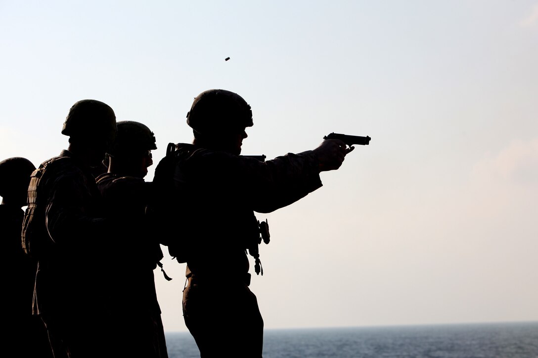 Marines assigned to Battery B, Battalion Landing Team 3/5, 15th Marine Expeditionary Unit, fire 9mm pistols during marksmanship training on the flight deck of the USS Rushmore, March, 9.  Using the M9 Beretta, each shooter went through an entire course of fire on the paper targets. The 15th MEU is deployed as part of the Peleliu Amphibious Ready Group as a U.S. Central Command theater reserve force, providing support for maritime security operations and theater security cooperation efforts in the U.S. 5th Fleet area of responsibility. (U.S. Marine Corps photo by Cpl. Timothy R. Childers/Released)