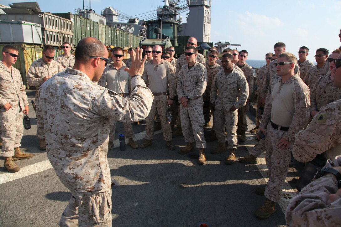 Gunnery Sgt. Gerald J. Furnari, staff non-commissioned officer-in-charge, Combined Anti-Armor Team II, Battalion Landing Team 3/5, 15th Marine Expeditionary Unit, conducts a safety brief before pistol marksmanship training on the flight deck of USS Rushmore, March 9.  Using the M9 Beretta, each shooter went through an entire course of fire on the paper targets. The 15th MEU is deployed as part of the Peleliu Amphibious Ready Group as a U.S. Central Command theater reserve force, providing support for maritime security operations and theater security cooperation efforts in the U.S. 5th Fleet area of responsibility. (U.S. Marine Corps photo by Cpl. Timothy R. Childers/Released)