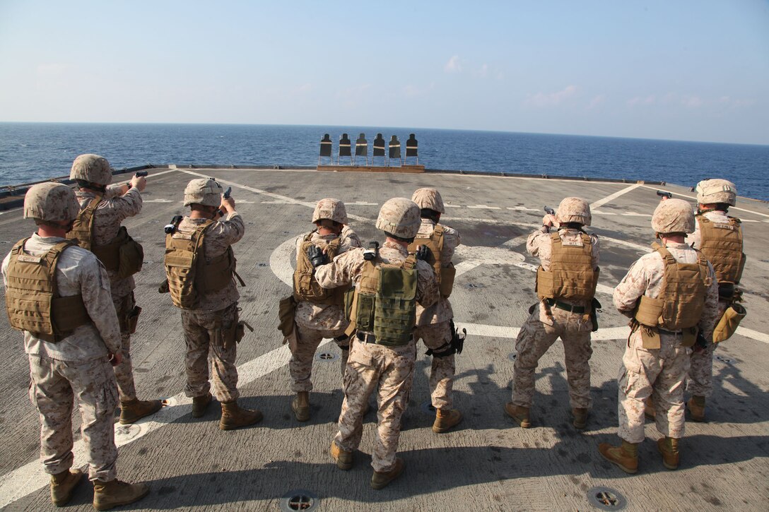 Marines assigned to Headquarters and Support Company, Battalion Landing Team 3/5, 15th Marine Expeditionary Unit, fire 9mm pistols during marksmanship training on the flight deck of USS Rushmore, March 9.  Using the M9 Beretta, each shooter went through an entire course of fire on the paper targets. The 15th MEU is deployed as part of the Peleliu Amphibious Ready Group as a U.S. Central Command theater reserve force, providing support for maritime security operations and theater security cooperation efforts in the U.S. 5th Fleet area of responsibility. (U.S. Marine Corps photo by Cpl. Timothy R. Childers/Released)
