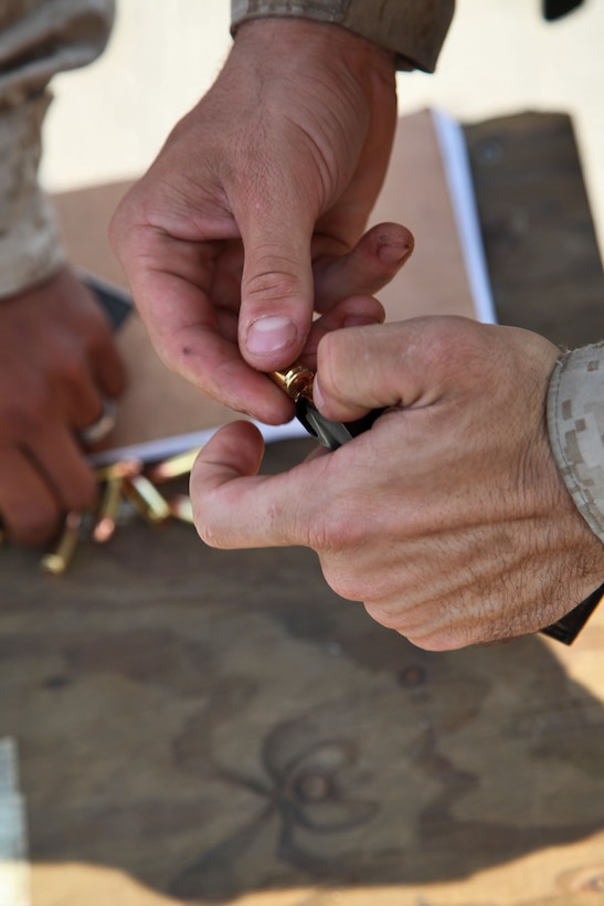 Marines assigned to Headquarters and Support Company, Battalion Landing Team 3/5, 15th Marine Expeditionary Unit, fire 9mm pistols during marksmanship training on the flight deck of USS Rushmore, March 9.  Using the M9 Beretta, each shooter went through an entire course of fire on the paper targets. The 15th MEU is deployed as part of the Peleliu Amphibious Ready Group as a U.S. Central Command theater reserve force, providing support for maritime security operations and theater security cooperation efforts in the U.S. 5th Fleet area of responsibility. (U.S. Marine Corps photo by Cpl. Timothy R. Childers/Released)