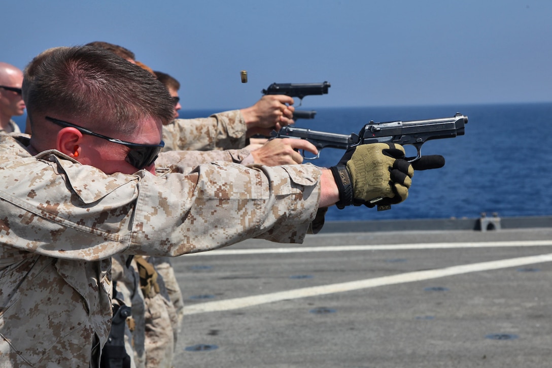 Sergeant Adam Scott, anti-tank missleman, Combined Anti-Armor Team II, Weapons Company, Battalion Landing Team 3/5, 15th Marine Expeditionary Unit, fire 9mm Pistols during marksmanship training on the flight deck of the USS Rushmore, March 9.  Using the M9 Beretta, each shooter went through an entire course of fire on the paper targets. The 15th MEU is deployed as part of the Peleliu Amphibious Ready Group as a U.S. Central Command theater reserve force, providing support for maritime security operations and theater security cooperation efforts in the U.S. 5th Fleet area of responsibility. (U.S. Marine Corps photo by Cpl. Timothy R. Childers/Released)