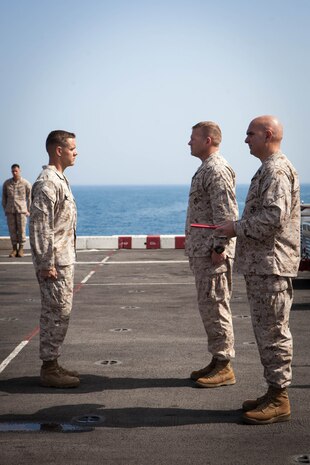 Major Matthew Peterson, operations officer, Battalion Landing Team 3/5, 15th Marine Expeditionary Unit, reports to Lt. Col. Christeon Griffin, his battalion commander, during a Bronze Star award ceremony, aboard USS Green Bay, March 3. Peterson received the award for his extraordinary guidance, zealous initiative and total dedication to duty while securing the historically violent and enemy controlled urban area of Wishtan and the surrounding region. The 15th MEU is deployed as part of the Peleliu Amphibious Ready Group as a U.S. Central Command theatre reserve force, providing support for maritime security operations and theatre security cooperation efforts in the U.S. 5th Fleet area of responsibility. (U.S. Marine Corps photo by Cpl. Bobby J. Gonzalez/Released)