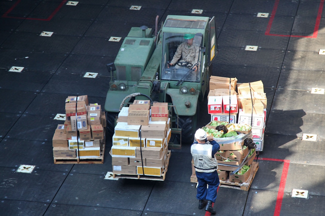Lance Cpl. Jacob F. Dyermills, heavy equipment operator, Engineer Detachment, Combat Logistics Battalion 15, 15th Marine Expeditionary Unit, brings a pallet of food from a Landing Craft Utility into the well deck of the USS Rushmore, during a replenishment at sea, March 8. The 15th MEU is deployed as part of the Peleliu Amphibious Ready Group as a U.S. Central Command theater reserve force, providing support for maritime security operations and theater security cooperation efforts in the U.S. 5th Fleet area of responsibility. (U.S. Marine Corps photo by Cpl. Timothy R. Childers/ Released)
