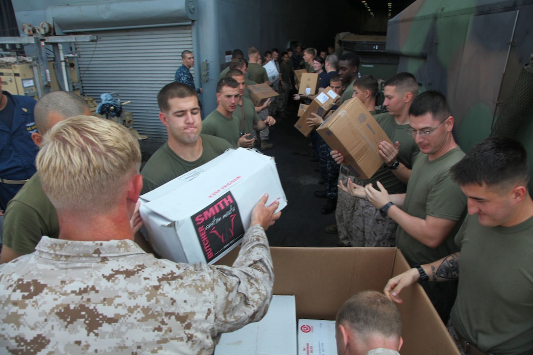 Marines and sailors aboard the USS Rushmore conduct a replenishment at sea, receiving 10 pallets of food from the USS Peleliu by Landing Craft Utility, March 8. The 15th MEU is deployed as part of the Peleliu Amphibious Ready Group as a U.S. Central Command theater reserve force, providing support for maritime security operations and theater security cooperation efforts in the U.S. 5th Fleet area of responsibility. (U.S. Marine Corps photo by Cpl. Timothy R. Childers/ Released)