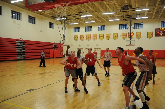Players from TBS Ordnance and CI Weapons battle for position during an intramural basketball game at Barber Physical Activity Center on March 4. Weapons prevailed 53-52.