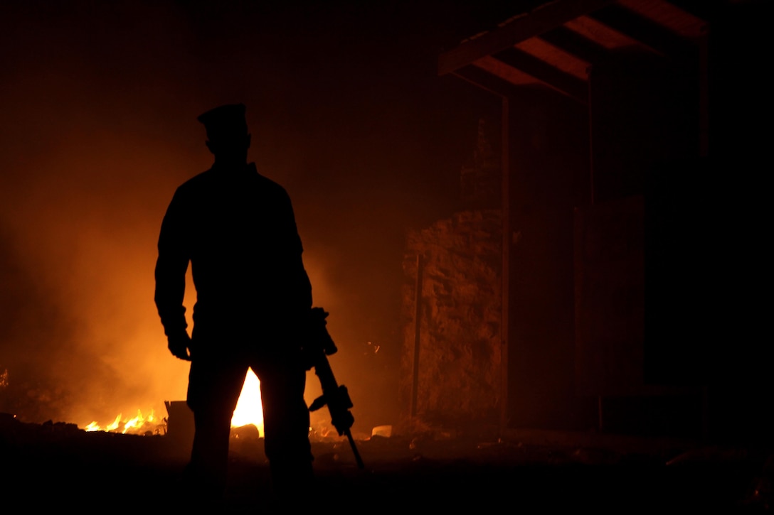 U.S. Marine with the Warfighter Exchange Service Team (WES Team), Combat Logistics Regiment 2, walks away after disposing of trash at the burn pit in Forward Operating Base (FOB) Zeebrudge, Helmand province, Afghanistan, March 6, 2013. The WES Team travels to Patrol Bases and FOBs from Camp Leatherneck to provide PX supplies, cash and postal services to fellow deployed servicemembers that are normally not accessible. (U.S. Marine Corps photo by Sgt. Anthony L. Ortiz / Released)