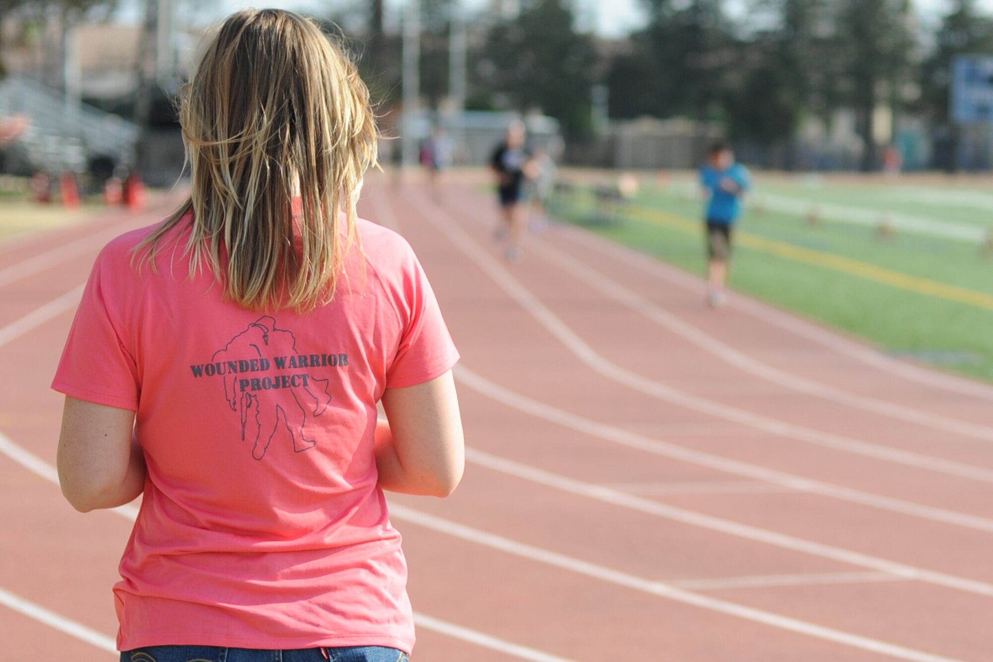 YOKOTA AIR BASE, Japan -- Monica Strong, a volunteer, cheers on runners at the Wounded Warrior Project 24-hour Vigil Run March 9, 2013, at Yokota Air Base, Japan. More than 500 runners participated in the run, which benefitted the Wounded Warrior Project. (U.S. Air Force photo by Airman 1st Class Desiree Economides)