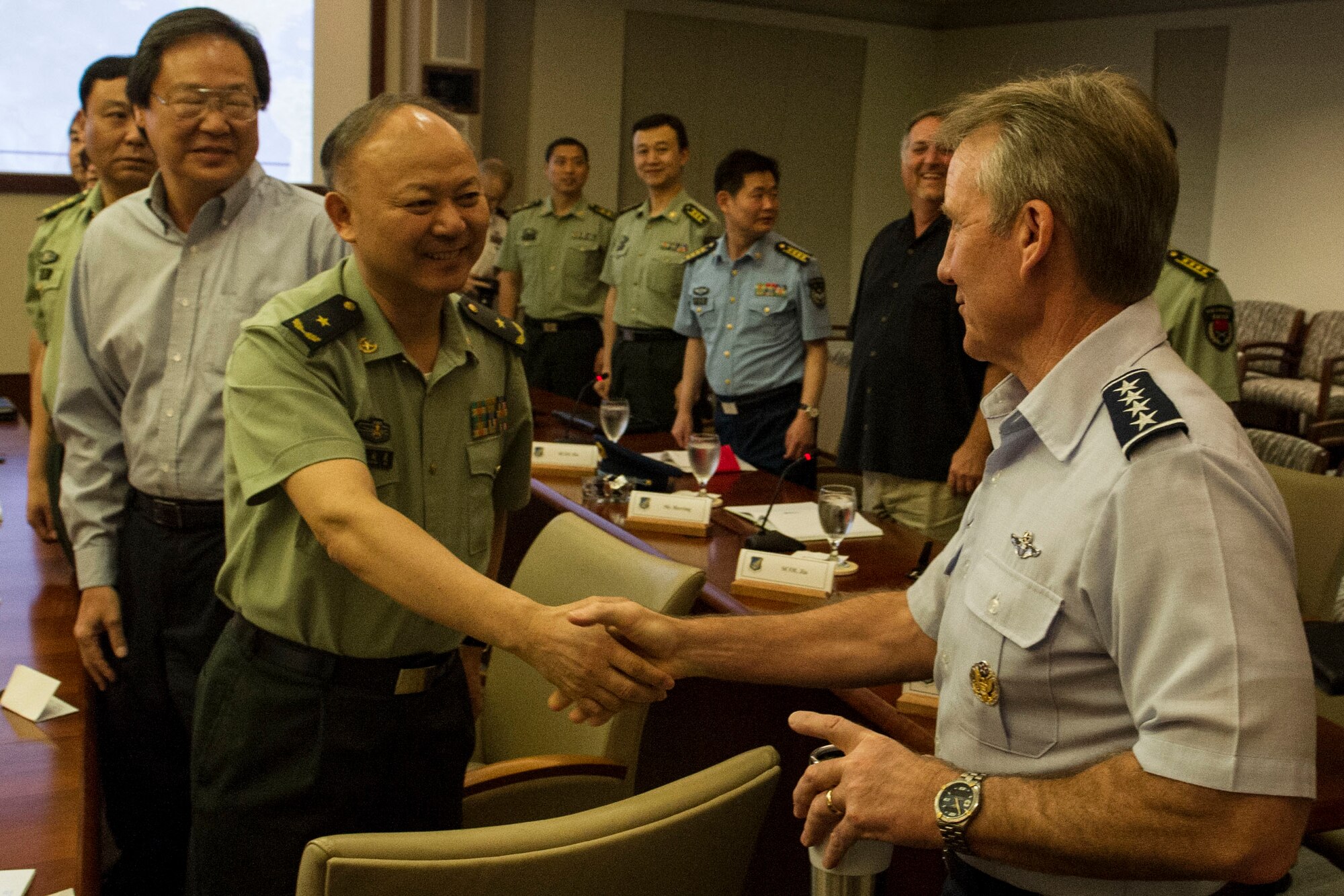Gen. Hawk Carlisle, Pacific Air Forces commander, meets with members of the People’s Liberation Army of China, the unified organization of China’s land, sea, and air forces, at the PACAF headquarters building March 8, 2013. Fourteen Chinese officers ranking between 0-4 and 0-8 visited U.S. Pacific Command and its service components as part of an agreed upon reciprocal visit between Chinese and American military officers. During their visit, the Chinese officers received a briefing from Carlisle on PACAF’s priorities, and viewed a C-17 Globemaster III. In the fall, mid-level officers from U.S. PACOM and its component commands will conduct a reciprocal visit to China in order to increase institutional understanding, exchange views on the international security environment, and identify further ways where our two militaries may work together to enhance stability, and maintain peace and security in the Pacific. (U.S. Air Force photo by Staff Sgt. Nathan Allen)