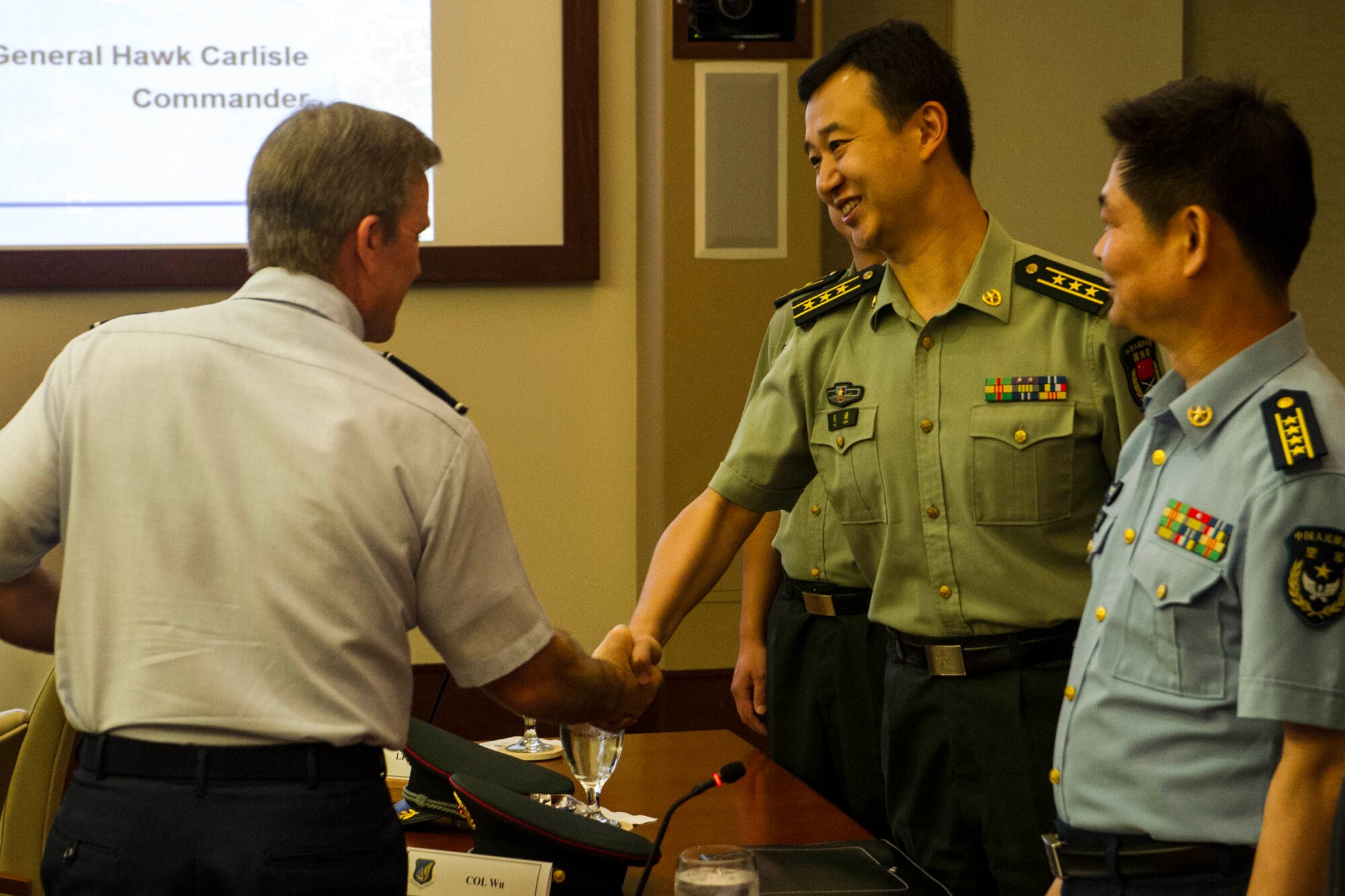 Gen. Hawk Carlisle, Pacific Air Forces commander, meets with members of the People’s Liberation Army of China, the unified organization of China’s land, sea, and air forces, at the PACAF headquarters building March 8, 2013. Fourteen Chinese officers ranking between 0-4 and 0-8 visited U.S. Pacific Command and its service components as part of an agreed upon reciprocal visit between Chinese and American military officers. During their visit, the Chinese officers received a briefing from Carlisle on PACAF’s priorities, and viewed a C-17 Globemaster III. In the fall, mid-level officers from U.S. PACOM and its component commands will conduct a reciprocal visit to China in order to increase institutional understanding, exchange views on the international security environment, and identify further ways where our two militaries may work together to enhance stability, and maintain peace and security in the Pacific. (U.S. Air Force photo by Staff Sgt. Nathan Allen)