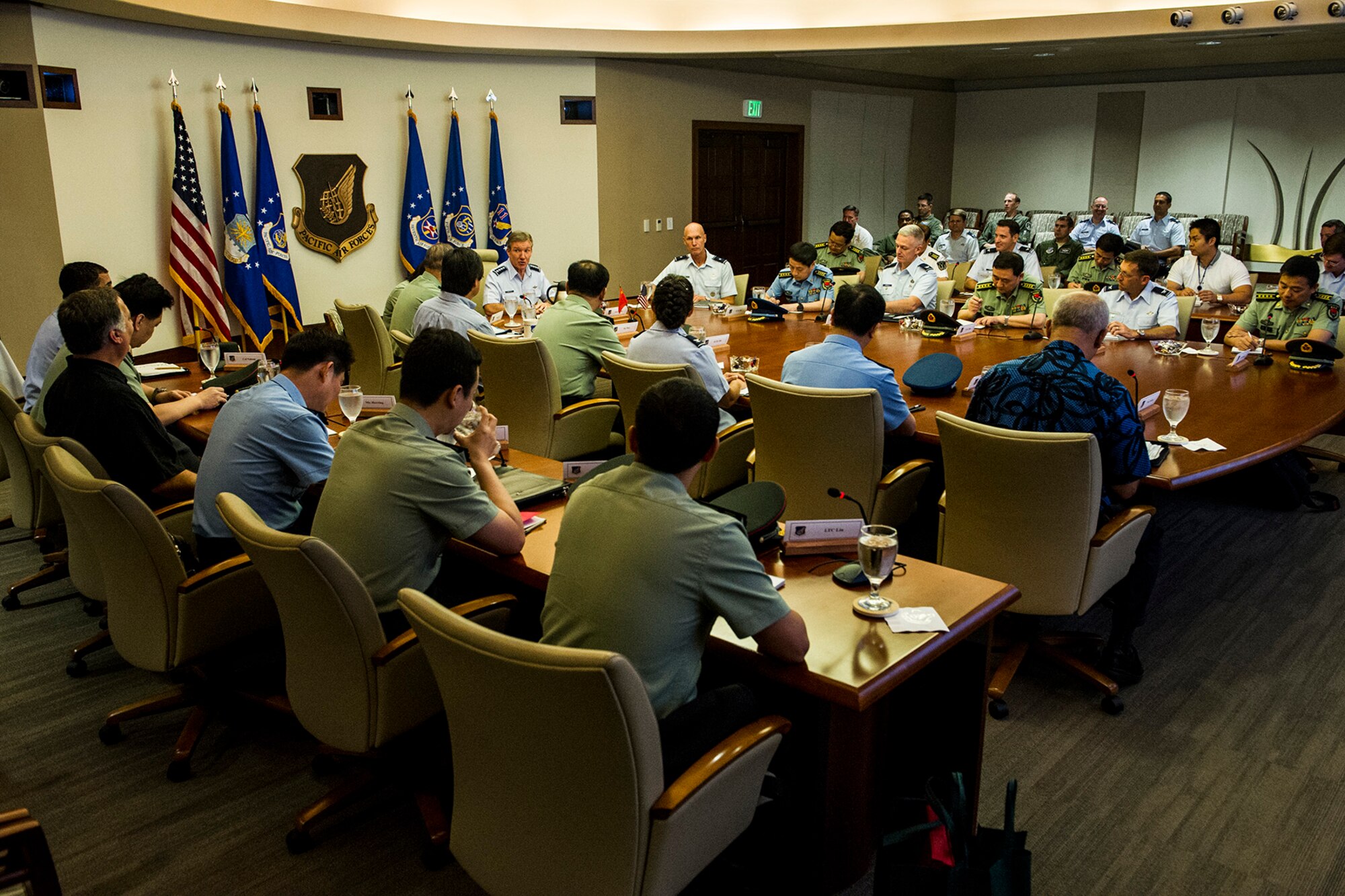 Gen. Hawk Carlisle, Pacific Air Forces commander, meets with members of the People’s Liberation Army of China, the unified organization of China’s land, sea, and air forces, at the PACAF headquarters building March 8, 2013. Fourteen Chinese officers ranking between 0-4 and 0-8 visited U.S. Pacific Command and its service components as part of an agreed upon reciprocal visit between Chinese and American military officers. During their visit, the Chinese officers received a briefing from Carlisle on PACAF’s priorities, and viewed a C-17 Globemaster III. In the fall, mid-level officers from U.S. PACOM and its component commands will conduct a reciprocal visit to China in order to increase institutional understanding, exchange views on the international security environment, and identify further ways where our two militaries may work together to enhance stability, and maintain peace and security in the Pacific. (U.S. Air Force photo by Staff Sgt. Nathan Allen)