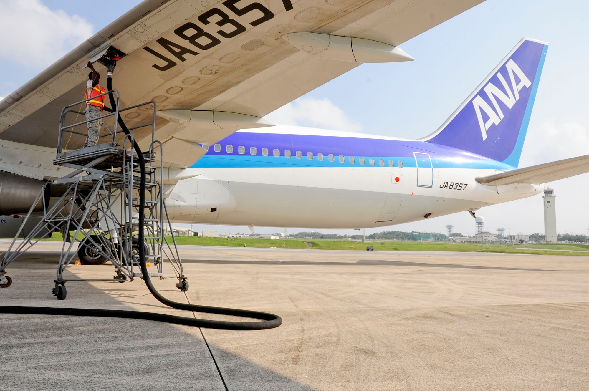 U.S. Air Force Staff Sgt. Charles Stepps, 18th Equipment Maintenance Squadron transient alert crew chief, refuels a commercial aircraft parked on the flightline of Kadena Air Base, Japan, March 12, 2013. The 18th Wing and 733rd AMS assisted three aircraft that diverted from Naha airfield with services such as refueling. Kadena Air Base is a divert location for Naha airfield and is occasionally used when weather or other situations prevent aircraft from landing at Naha. (U.S. Air Force photo/Staff Sgt. Darnell T. Cannady)