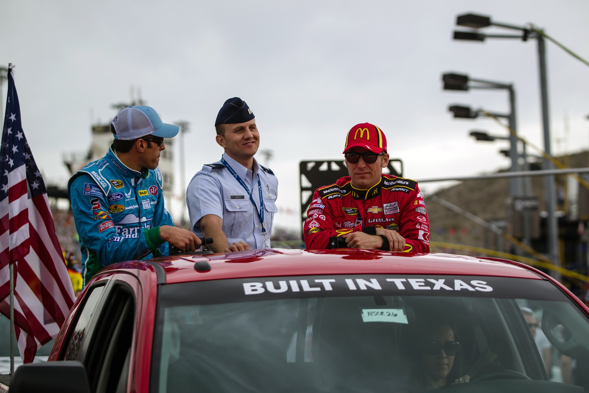 Chaplain Kevin Rash, 944th Fighter Wing, visits with NASCAR drivers after administer the oath of enlistment to 16 new recruits in front of thousands of NASCAR fans during the Subway Fresh Fit 500 NASCAR Sprint Cup Series at the Phoenix International Raceway Sunday. (Courtesy Photo)