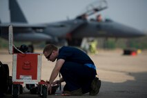 Airman 1st Class Tyler Olson, an avionics specialist, prepares an F-15C Eagle aircraft for flight operations during Cope Tiger 13 at Korat Royal Thai Air Force Base, Thailand, March 11, 2013. Olson is assigned to the 18th Aircraft Maintenance Squadron, Kadena Air Base, Japan. More than 300 U.S. service members are participating in CT13, which offers an unparalleled opportunity to conduct a wide spectrum of large force employment air operations and strengthen military-to-military ties with two key partner nations, Thailand and Singapore. (U.S. Air Force photo/2nd Lt. Jake Bailey)