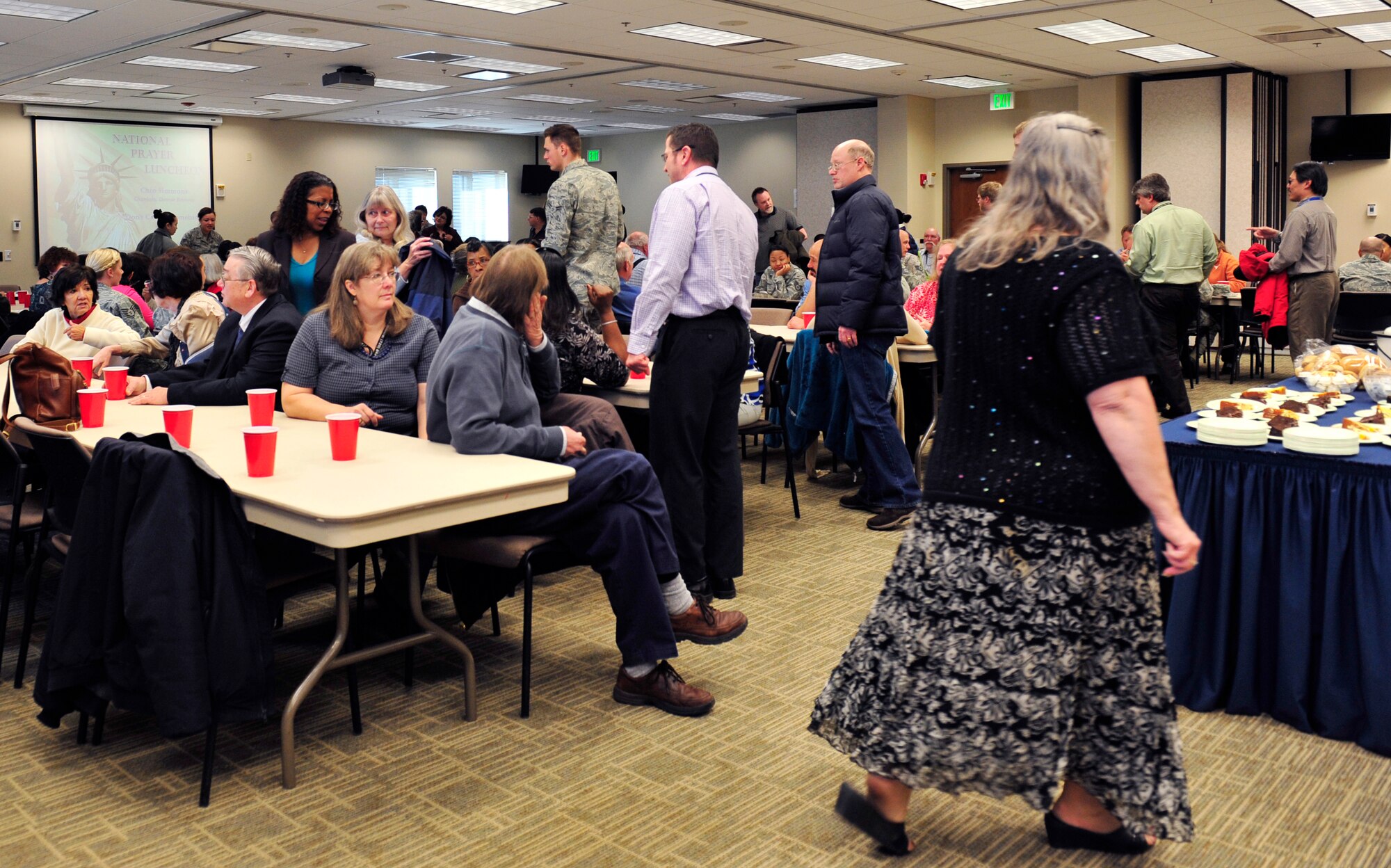 Participants of the annual National Prayer Luncheon meet and greet with one another before they share a meal March 6, 2013, at the chapel Fellowship Hall at Buckley Air Force Base, Colo. More than 220 military members and civilians fellowshipped, worshipped and feasted on food served by the chapel. (U.S. Air Force photo by Airman 1st Class Darryl Bolden Jr./Released)