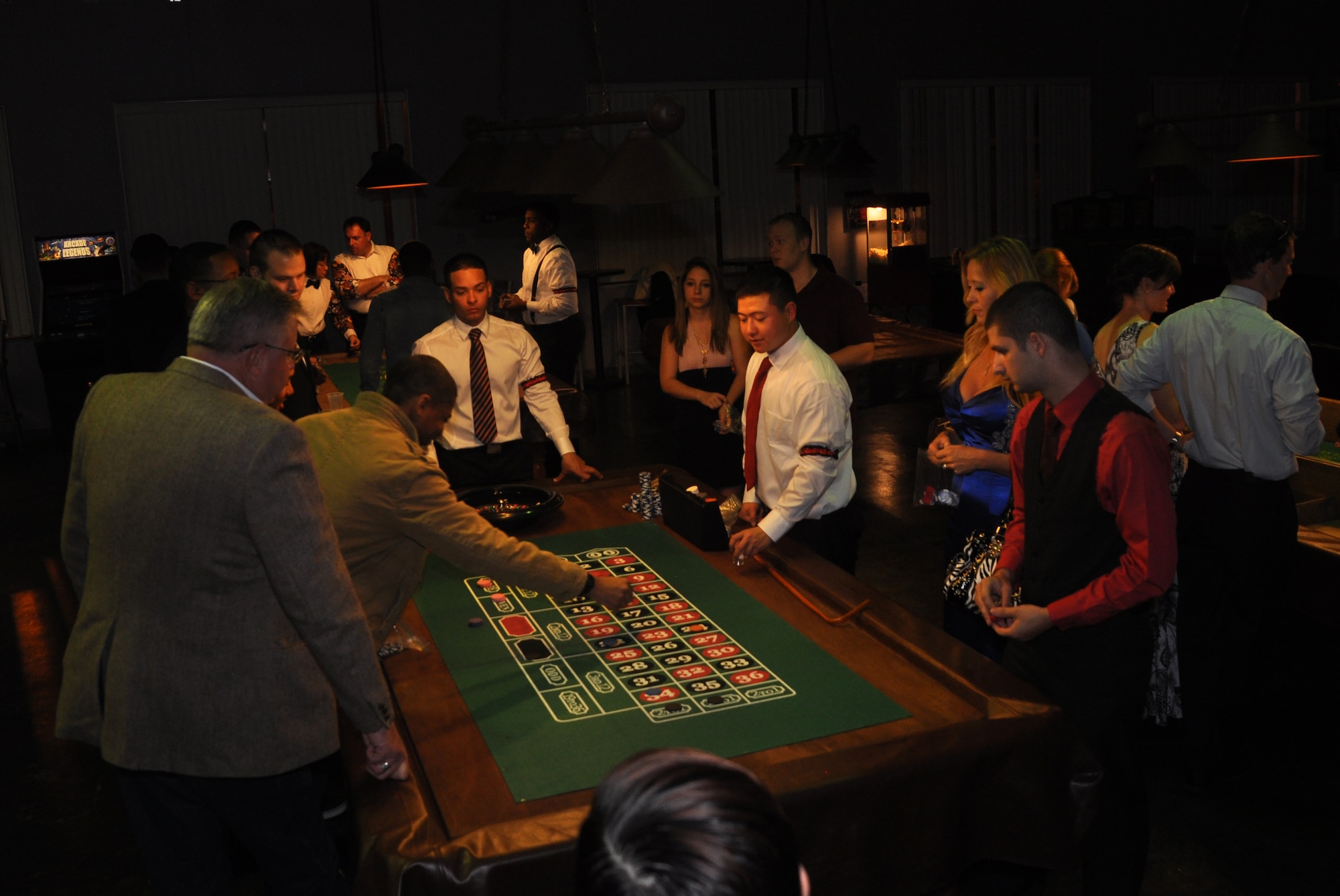 Airmen participate in a game of roulette during the complimentary Casino Royale Food Drive at the Landing Zone at Hurlburt Field, Fla., March 9, 2013. More than 100 Airmen participated in the event as part of the Single Airman Initiative. (Courtesy photo by Senior Airman Brandon Gilliatt)  