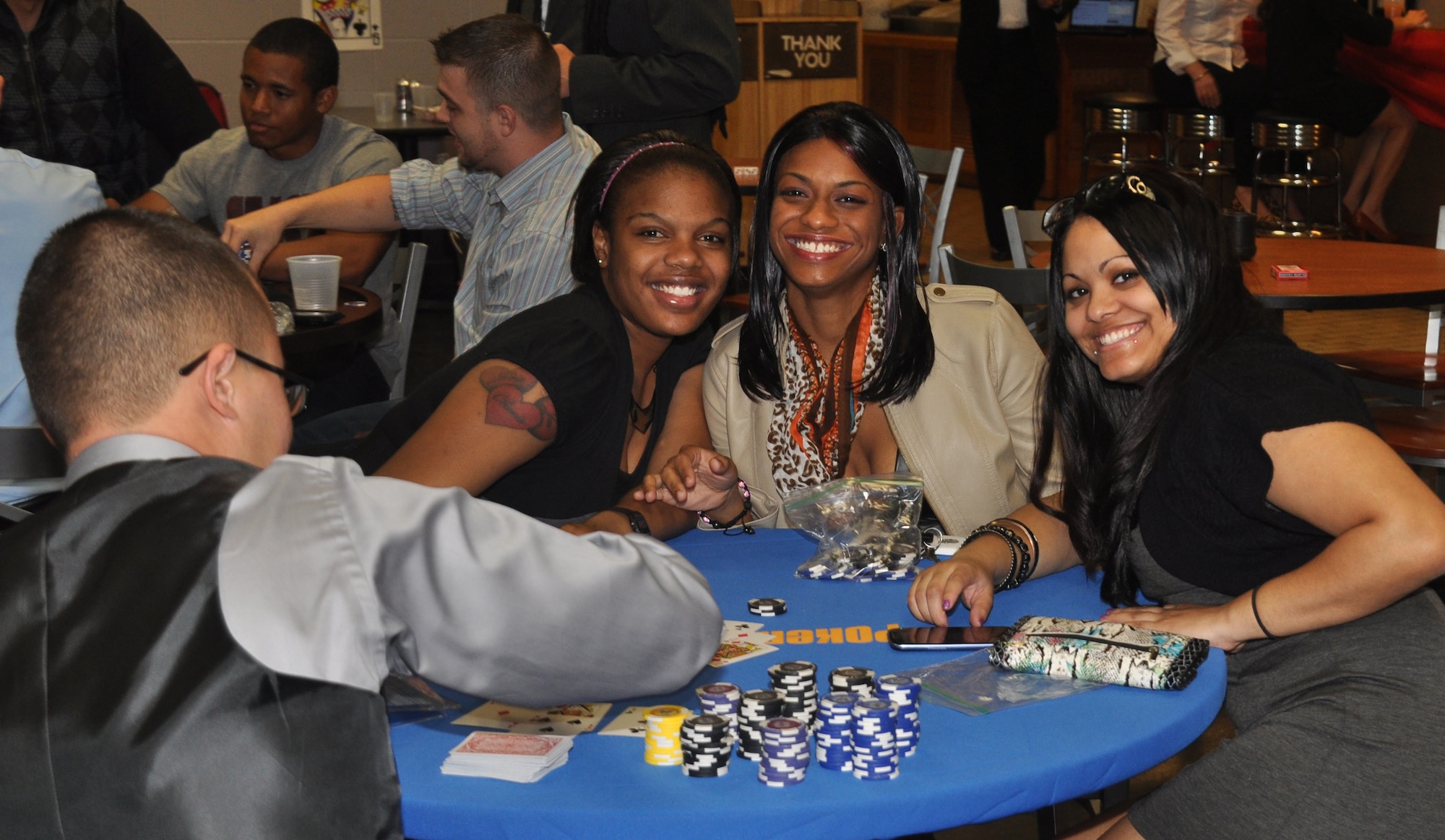 Airmen pose for a photo while taking a break during a card game at the complimentary Casino Royale Food Drive at the Landing Zone at Hurlburt Field, Fla., March 9, 2013. More than 100 Airmen participated in the event and raised more than 300 pounds of canned food for needy families. (Courtesy photo by Senior Airman Brandon Gilliatt)  