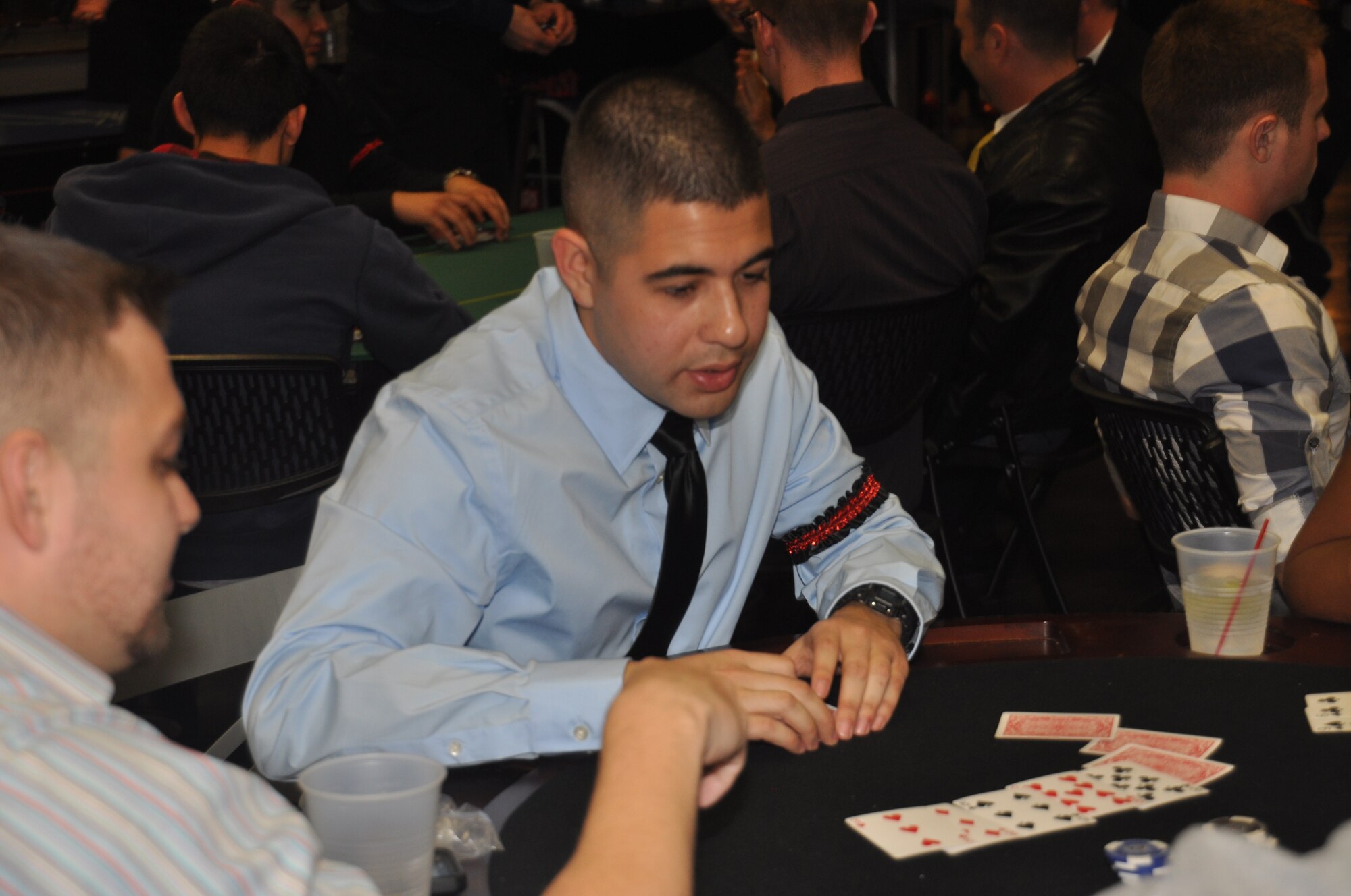 Airman 1st Class Brian Ocon, 1st Special Operations Communications Squadron and secretary of Hurlburt Airman's Voice, deals a hand of cards during the complimentary Casino Royale Food Drive at the Landing Zone at Hurlburt Field, Fla., March 9, 2013. The Landing Zone staff partnered with junior enlisted Airmen to provide the event as well as raise more than 300 pounds of canned food for needy families. (Courtesy photo by Senior Airman Brandon Gilliatt)  