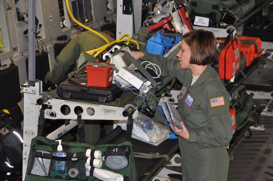 Staff Sgt. Sara Eldred, 775th Expeditionary Aeromedical Evacuation Flight medical technician deployed from Stratton Air National Guard Base, N.Y., prepares equipment on a C-17 Globemaster III at Travis. Aeromedical evacuation crews at Travis are one of the last crews to care for wounded warriors before they arrive at home. (U.S. Air Force photo/1st Lt. Angela Martin) 

