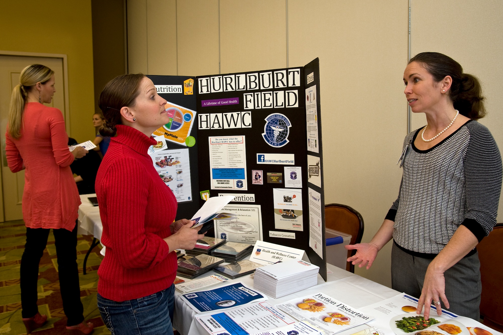 Sarah Luna, key spouse for 10th Combat Weather Squadron and wife of Tech. Sgt. Mario Luna, gains information about the health and wellness center’s programs from Anna Armstrong, health promotion educator at the HAWC, during the Key Spouse Networking Fair at the Soundside Club on Hurlburt Field, Fla., March 11, 2013. The Key Spouse Networking Fair gave key spouses the opportunity to learn about base resources that can assist Air Force families.