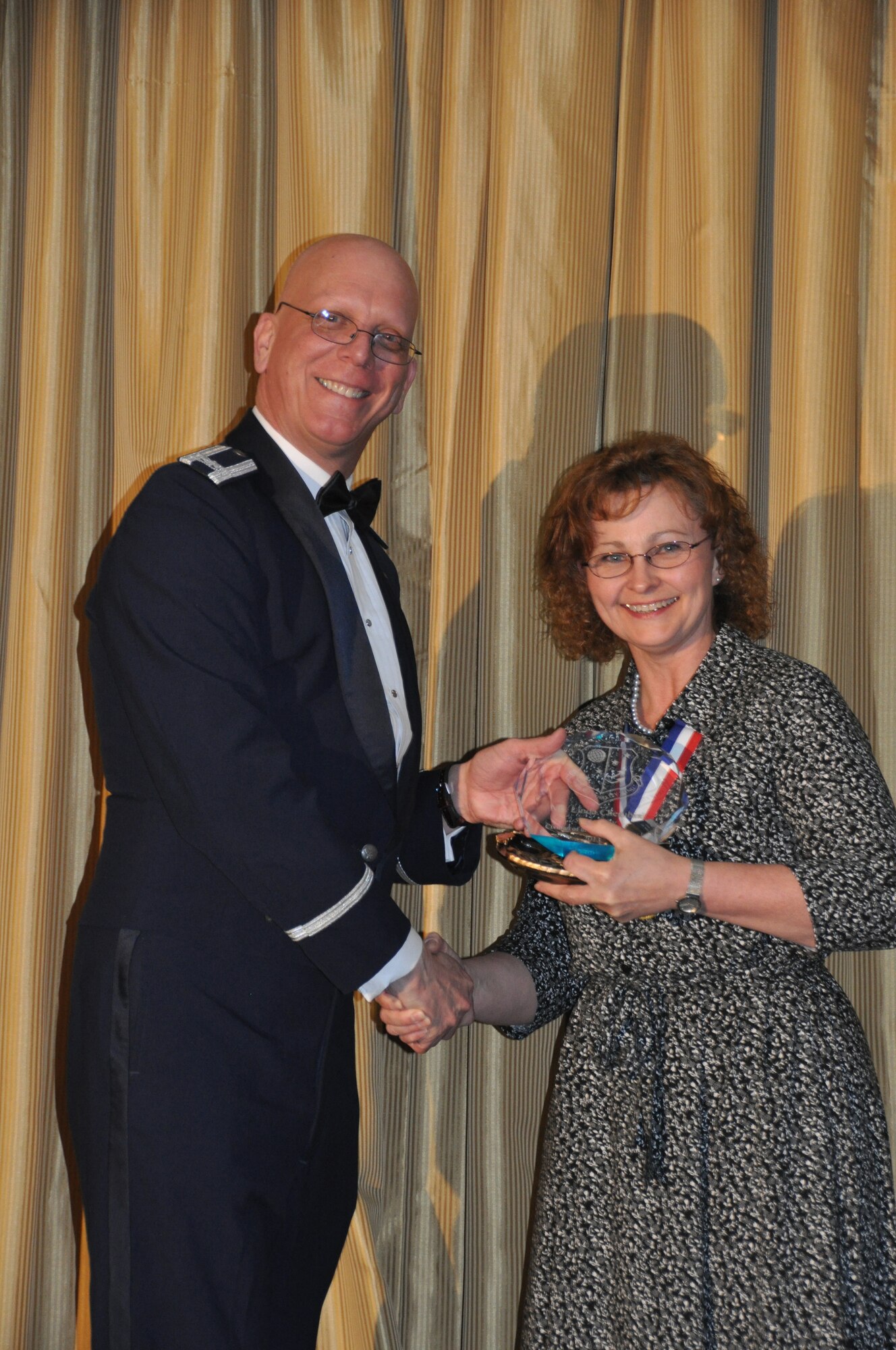 JOINT BASE MCGUIRE-DIX-LAKEHURST, N.J. - Ms. Linda Cherubini of the 514th Force Support Squadron was selected as the Category I, 514th Outstanding Civilian of the Year 2012. Col. Michael Underkofler, 514th Air Mobility Wing commander presented Cherubini with a crystal plaque during the annual awards banquet held here on March 9. (U.S. Air Force photo/Master Sgt. Donna T. Jeffries) 