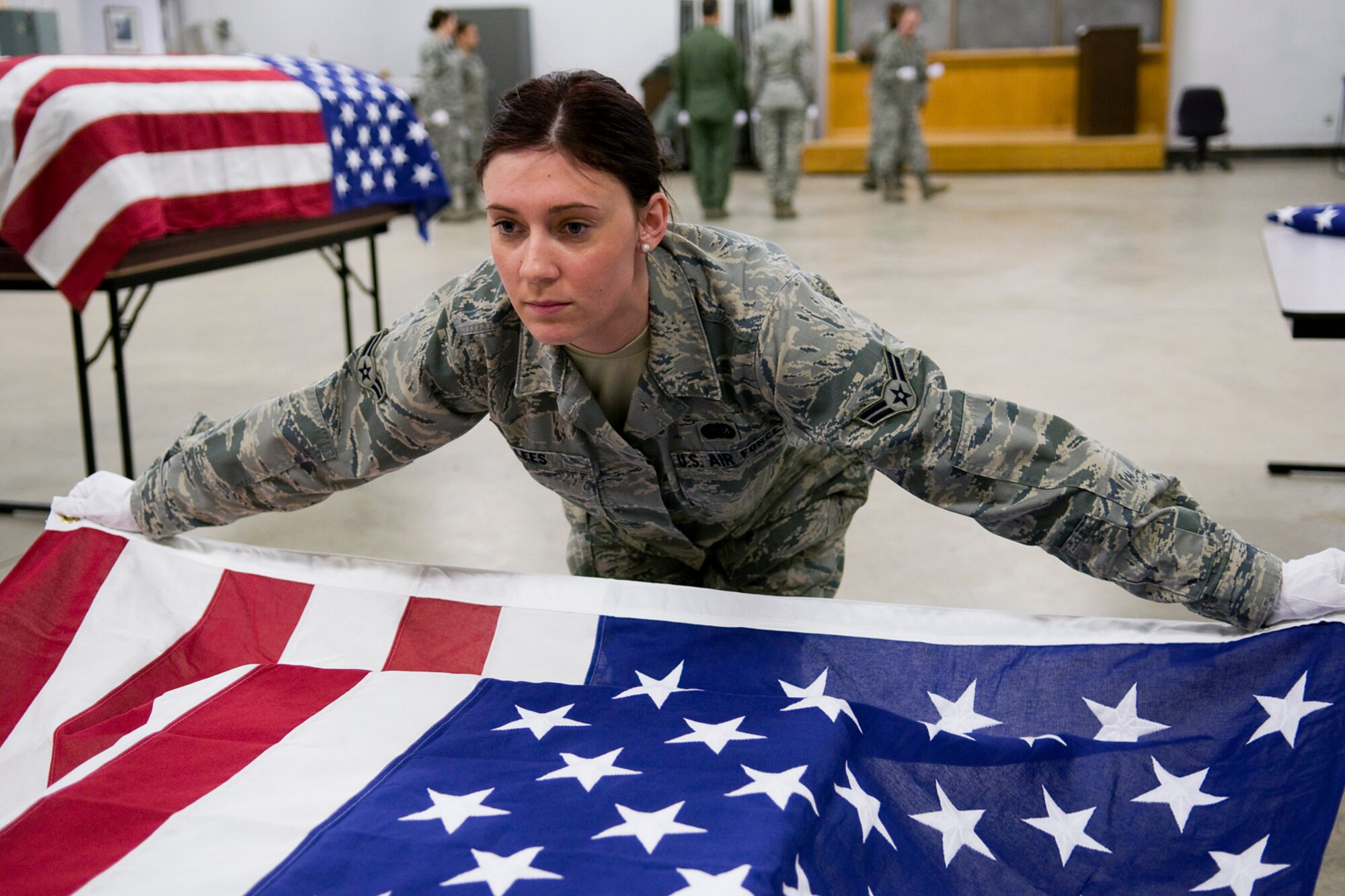 GRISSOM AIR RESERVE BASE, Ind. -- Airman 1st Class Tara Lees, 434th Force Support Squadron services apprentice, makes eye contact with her partner before proceeding to fold an American flag during honor guard training held here March 4. Many ceremonial moves made by honor guard members are coordinated silently with looks and other nonverbal communications. (U.S. Air Force photo/Tech. Sgt. Mark R. W. Orders-Woempner)
