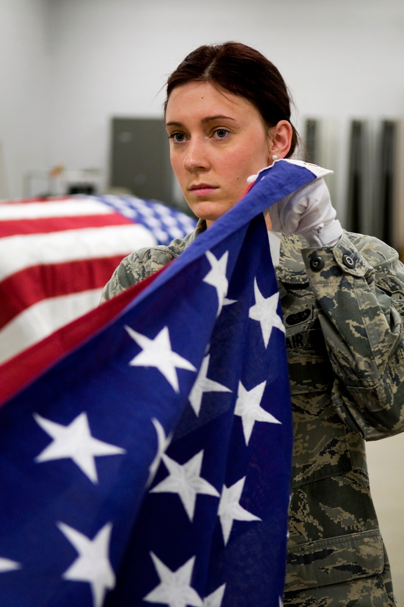 GRISSOM AIR RESERVE BASE, Ind. -- Airman 1st Class Tara Lees, 434th Force Support Squadron services apprentice, folds an American flag during honor guard training held here March 4. Ceremonial guardsmen have a unique role of providing final military honors to a deceased veteran, retiree or active-duty Airman along with honoring the nation and its flag through special ceremonies at schools, churches, sporting venues and other special events. (U.S. Air Force photo/Tech. Sgt. Mark R. W. Orders-Woempner)
