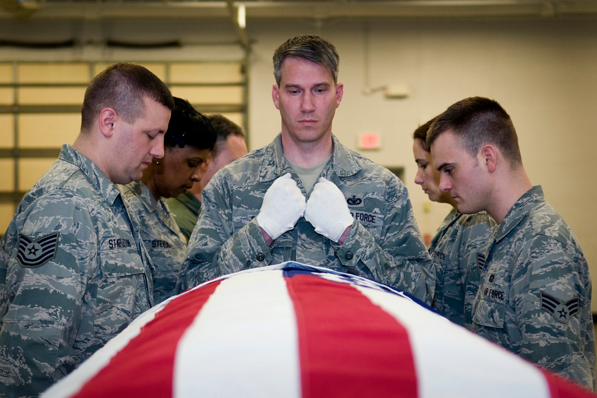 GRISSOM AIR RESERVE BASE, Ind. -- Staff Sgt. Ben Durr, 434th Security Forces Squadron security response team member, approaches a casket in the position of hand-off during a recent honor guard training here March 5. Also pictured, from left to right, are Tech. Sgt. Nicholas Stapleton, 434th SFS fire team member; Senior Airman Sharon Stevens, 434th Aerospace Medicine Squadron dental technician; Master Sgt. Ken Knight, 72nd Air Refueling Squadron boom operator; Tech. Sgt. Jennifer Steager, 434th AMDS health services management technician; and Senior Airman Brian Humphrey, 434th Civil Engineer Squadron heating, ventilation and air conditioning apprentice. (U.S. Air Force photo/Tech. Sgt. Mark R. W. Orders-Woempner)
