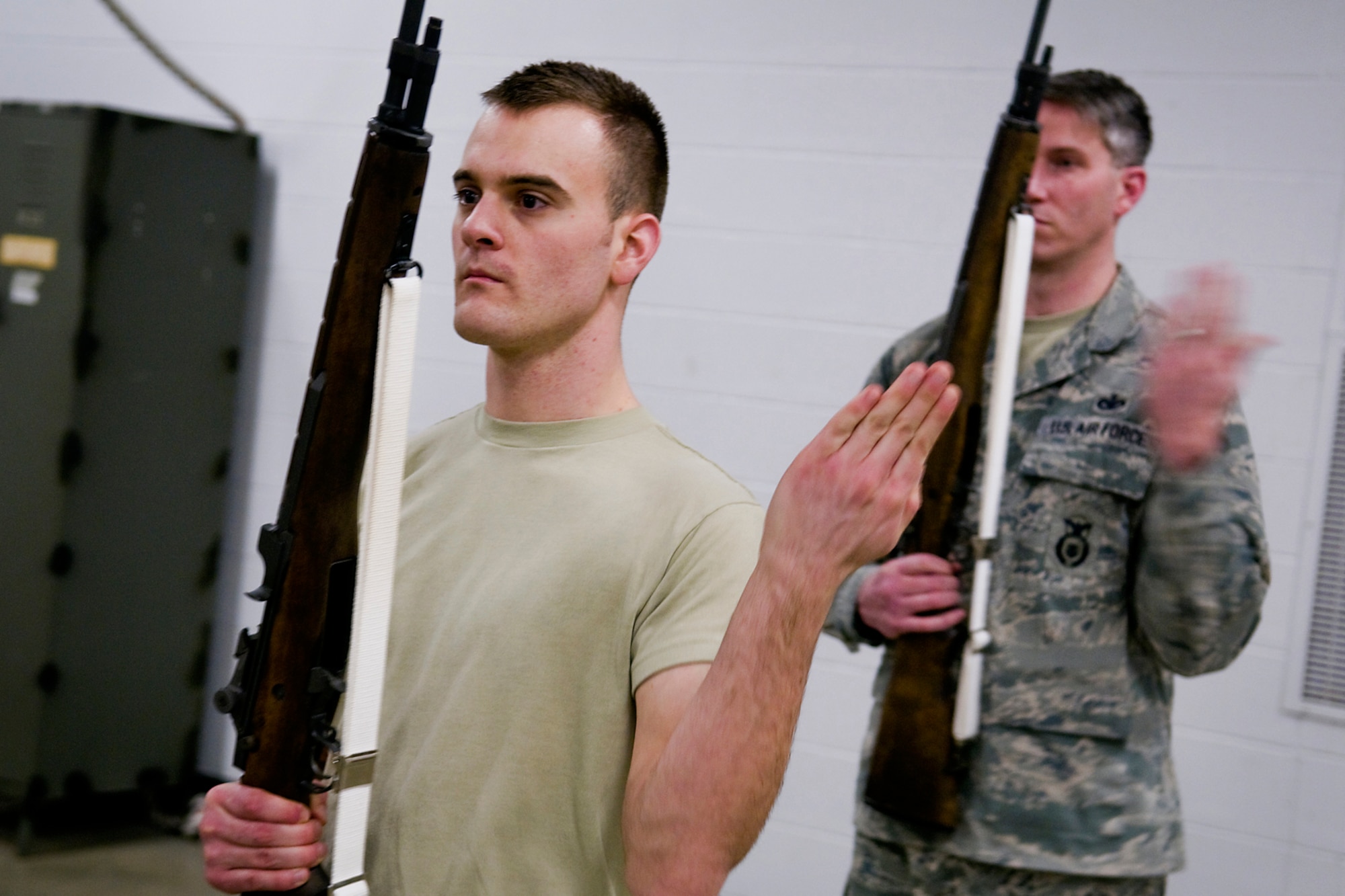 GRISSOM AIR RESERVE BASE, Ind. -- Staff Sgt. Ben Durr, 434th Security Forces Squadron security response team member, and Senior Airman Brian Humphrey, 434th Civil Engineer Squadron heating, ventilation and air conditioning apprentice, practice firing M-14 rifles during an honor guard training here March 6. The week-long training included instruction on honor guard facing movements, flag folding, casket bearing and weapons. (U.S. Air Force photo/Tech. Sgt. Mark R. W. Orders-Woempner) 
