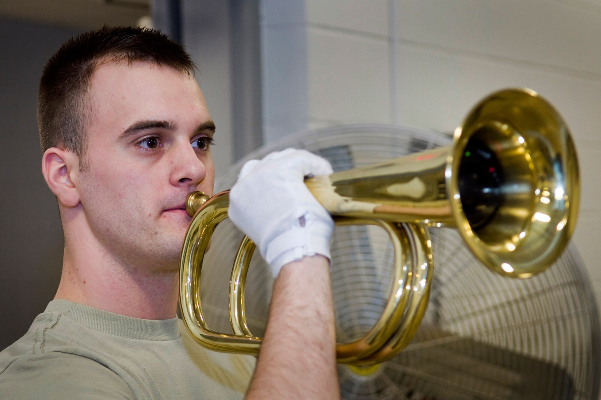 GRISSOM AIR RESERVE BASE, Ind. -- Senior Airman Brian Humphrey, 434th Civil Engineer Squadron heating, ventilation and air conditioning apprentice, plays taps during an honor guard training here March 6. Ceremonial guardsmen have a unique role of providing final military honors to a deceased veteran, retiree or active-duty Airman along with honoring the nation and its flag through special ceremonies at schools, churches, sporting venues and other special events. (U.S. Air Force photo/Tech. Sgt. Mark R. W. Orders-Woempner)
