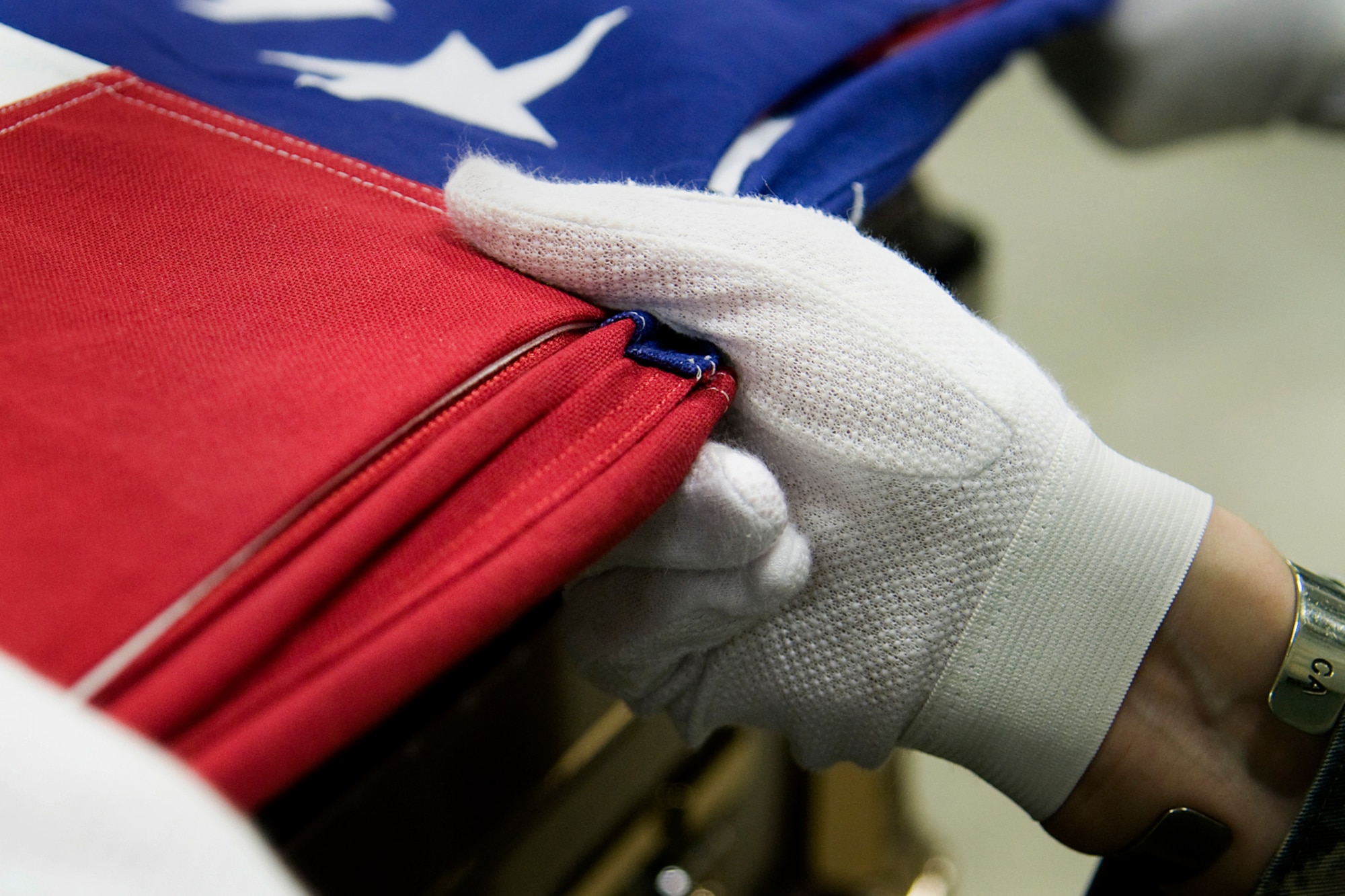 GRISSOM AIR RESERVE BASE, Ind. -- Tech. Sgt. Jennifer Steager, 434th Aerospace Medicine Squadron health services management technician, holds an American flag tight as she and other Grissom ceremonial guardsmen fold the flag during an honor guard training held here March 6. The week-long training included instruction on honor guard facing movements, flag folding, casket bearing and weapons. (U.S. Air Force photo/Tech. Sgt. Mark R. W. Orders-Woempner)
