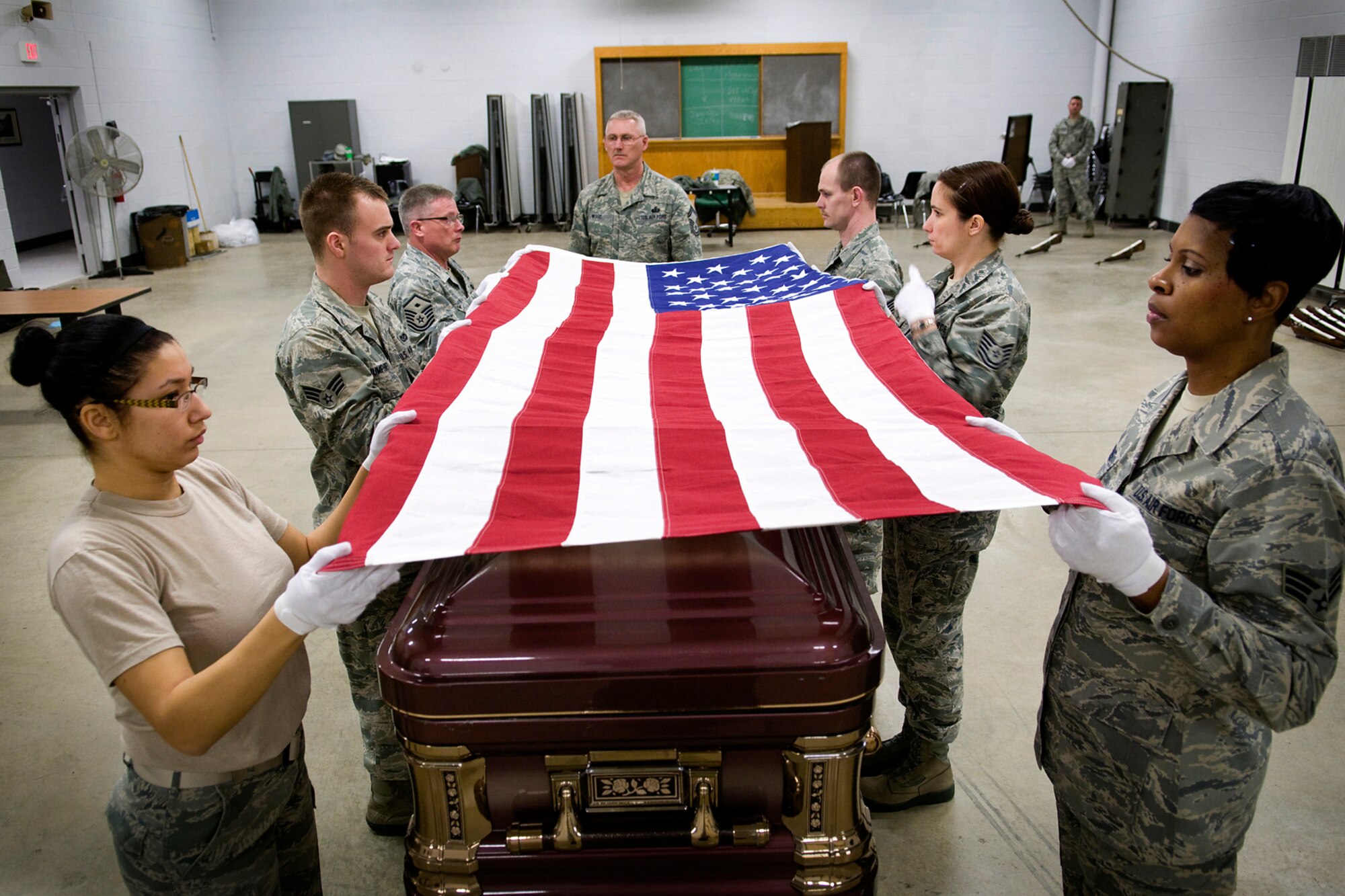 GRISSOM AIR RESERVE BASE, Ind. -- Senior Master Sgt. Timothy Wood, center, watches members of the Grissom Air Reserve Base Honor Guard fold a flag during honor guard training March 6. The week-long training included instruction on honor guard facing movements, flag folding, casket bearing and weapons. (U.S. Air Force photo/Tech. Sgt. Mark R. W. Orders-Woempner)
