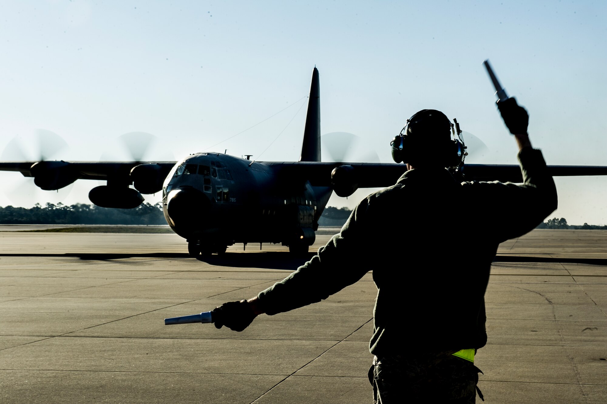 U.S. Air Force Airman 1st Class John Mckiddy helps taxi a C-130E Hercules before its final take off to retirement at the flight line on Hurlburt Field, Fla., March 4, 2013. The aircraft was first used by the U.S. Navy in 1965 and flown by VR-22 HAD Naval Air Transport Wing Pacific, which flew the aircraft during the Vietnam War. (U.S. Air Force photo/Airman 1st Class Christopher Callaway) 