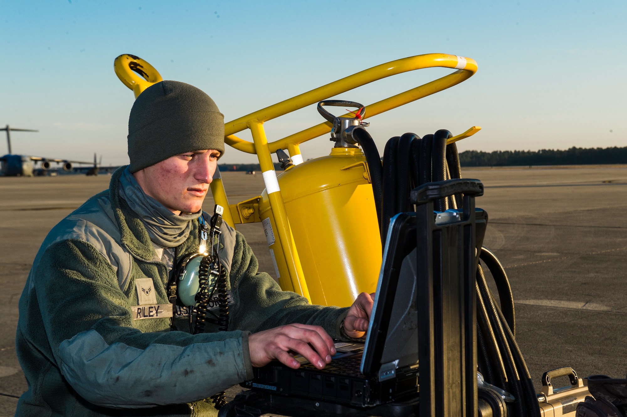 U.S. Air Force Airman 1st Class Drew Riley, a crew chief for 4th Aircraft Maintenance Unit, starts a laptop before preparing a C-130E Hercules for take-off at the flight line on Hurlburt Field, Fla., March 4, 2013. This aircraft has flown more than three times the amount of hours as any other aircraft on Hurlburt Field with over 28,000 hours total. (U.S. Air Force photo/Airman 1st Class Christopher Callaway) 