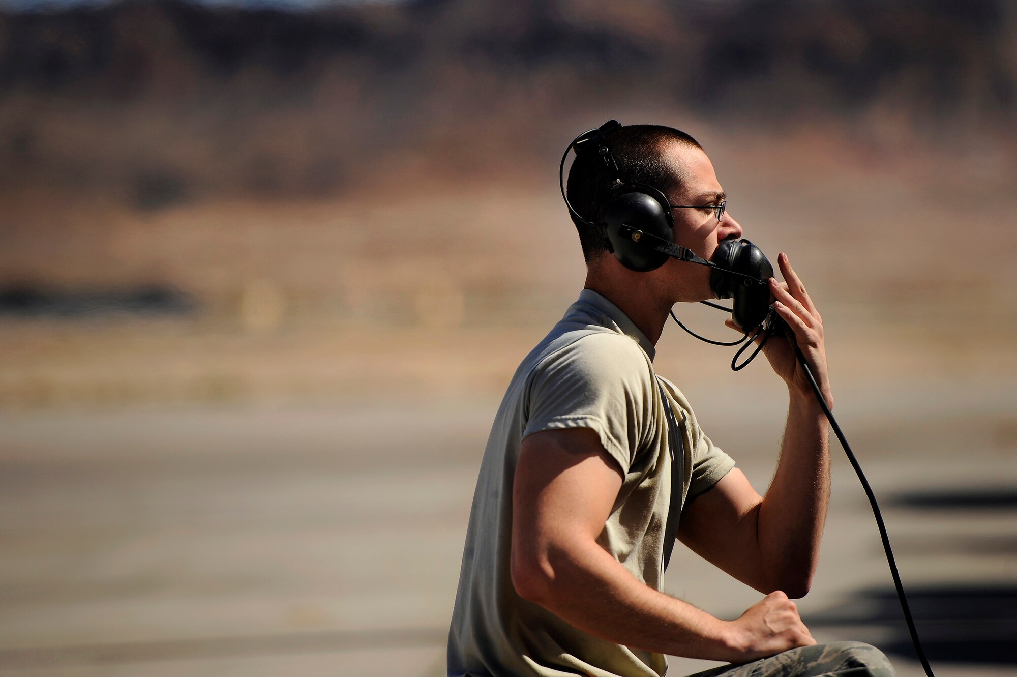 A U.S. Air Force crew chief assigned to the 20th Aircraft Maintenance Squadron uses his headset to communicate with a 79th Fighter Squadron ‘Tigers’ pilot while conducting preflight checks before takeoff during Red Flag 13-3, March 11, 2013, Nellis Air Force Base, Nev. About 23 crew chiefs from Shaw are participating in the Red Flag exercise. They have worked around the clock maintaining 79th FS jets so the pilots of the squadron are able to fly and get the training they need during each day of the exercise. (U.S. Air Force photo by Staff Sgt. Kenny Holston/Released)  