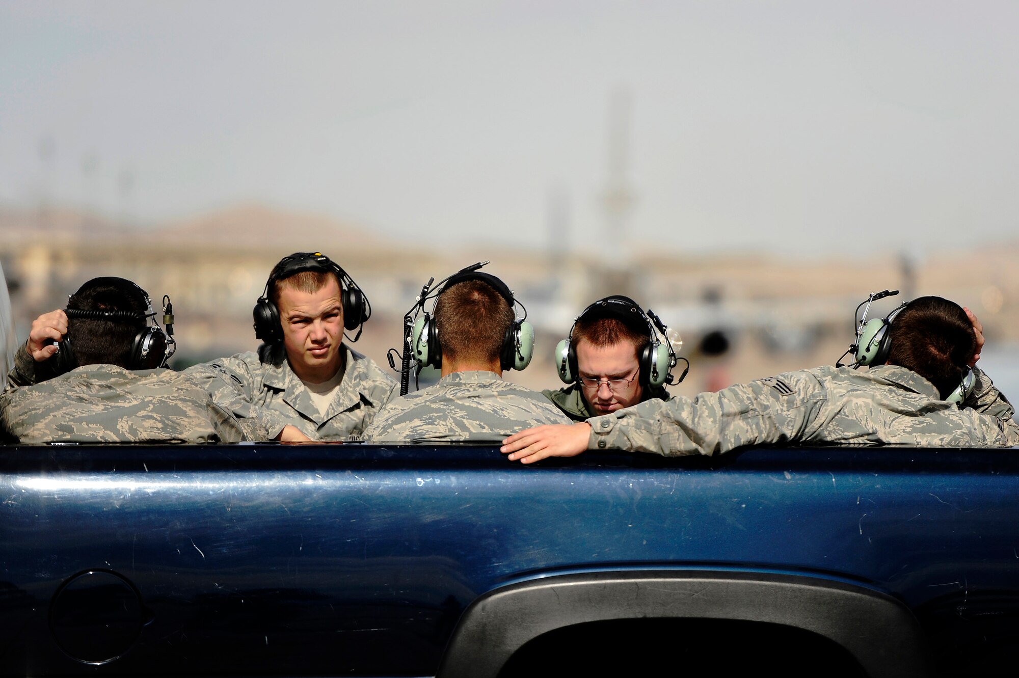 U.S. Air Force crew chiefs assigned to the 20th Aircraft Maintenance Squadron sit in the back of truck while waiting to be transported from the aircraft parking ramp back to their hangar after launching several F-16 Fighting Falcons for the 79th Fighter Squadron at Red Flag 13-3, March 6, 2013, Nellis Air Force Base, Nev. About 23 crew chiefs from Shaw are participating in the Red Flag exercise. They have worked around-the-clock maintaining 79th FS jets so the pilots of the squadron are able to fly and get the training they need during each day of the exercise. (U.S. Air Force photo by Staff Sgt. Kenny Holston/Released) 