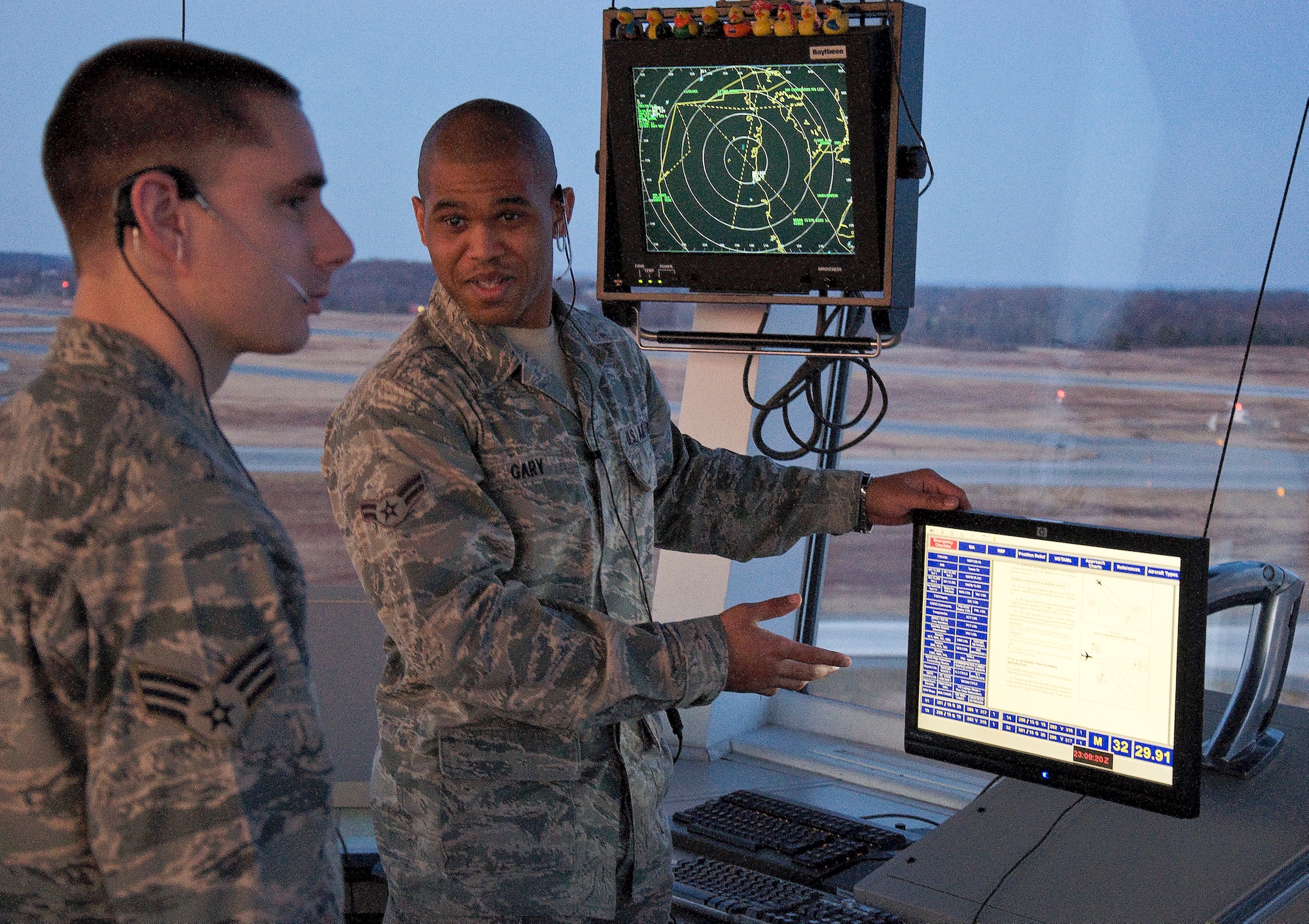 Airman 1st Class Paul Gary, 436th Operations Support Squadron air traffic control apprentice, explains intersection runway separation to his trainer, Senior Airman Jaesun Brown, 436th Operations Support Squadron air traffic control journeyman, while utilizing the information display system Mar. 4, 2013, in the Air Traffic Control Tower on Dover Air Force Base, Del. Gary was one of five air traffic controllers to win Lt. Gen. Gordon A. Blake Aircraft Assist Award for preventing an aircraft from striking a deer on the runway before takeoff. (U.S. Air Force photo/Senior Airman Jared Duhon)