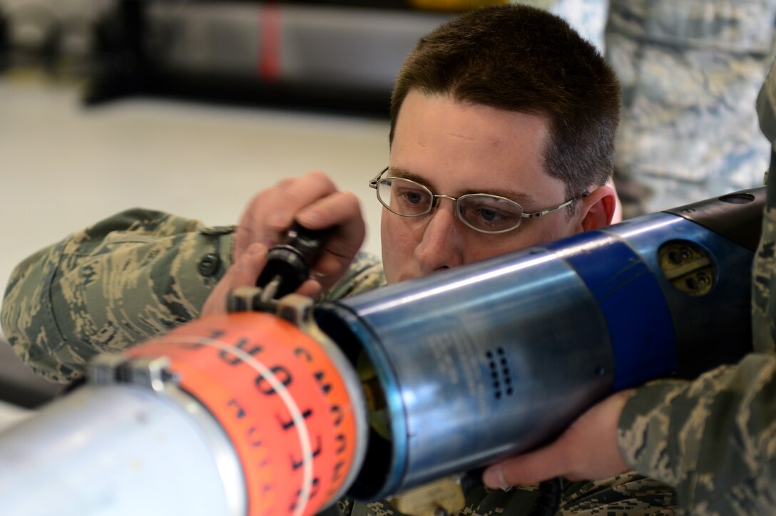 U.S. Air Force Senior Airman Brian Thornton, 1st Maintenance Squadron precision guidance munitions technician, disassembles an Air Intercept Missile 9 for its 180-day inspection at Langley Air Force Base, Va., March 5, 2013.  The productions section of Ammo provides munitions support for the flight line and is broken down into four smaller sections consisting of 100 military personnel – precision guided munitions, conventional maintenance, line delivery and equipment maintenance. (U.S. Air Force photo by Senior Airman Kayla Newman/Released)