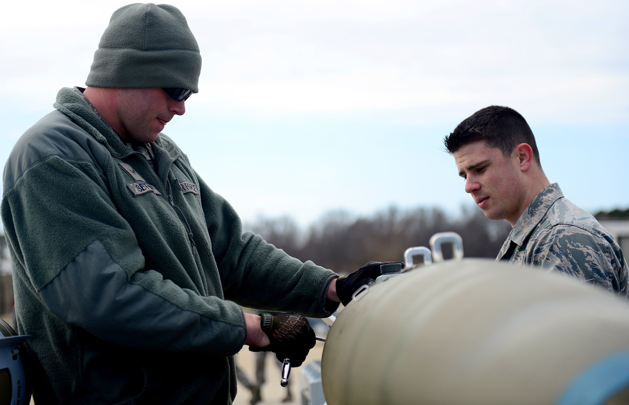 U.S. Air Force Airman 1st Class Douglas Setter and Senior Airman Travis Holmes, 1st Maintenance Squadron munitions flight technicians, build Guided Bomb Unit 32s on a munitions assembly conveyer at Langley Air Force Base, Va., March 5, 2013. The Munitions Flight is in charge of providing munitions support for Joint Base Langley-Eustis. (U.S. Air Force photo by Senior Airman Kayla Newman/Released)