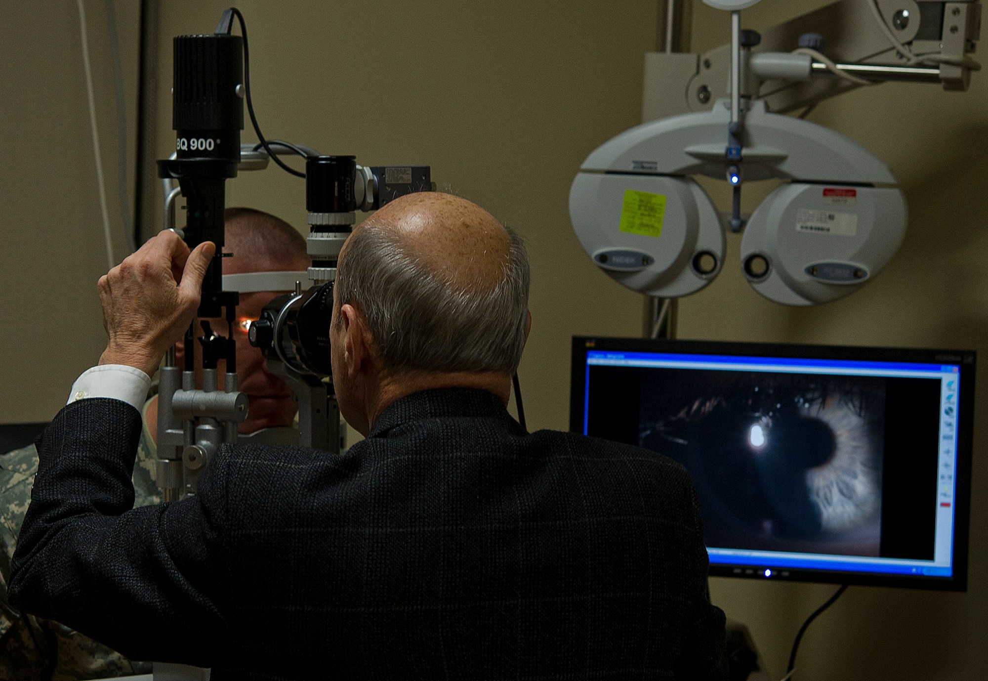 James Colgain, 779th Medical Group optometrist, uses a VK Digital slit lamp camera to take a picture of the patient's cornea at Joint Base Andrews, Md. The binocular slit-lamp examination provides a stereoscopic magnified view of the eye structures in detail, enabling anatomical diagnoses to be made for a variety of eye conditions.(U.S. Air Force photo/Staff Sgt. Perry Aston)
